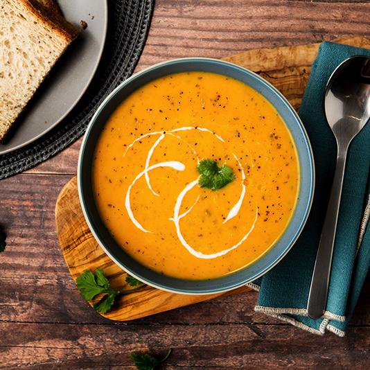 A bowl of Bay's Kitchen Carrot & Corriander soup