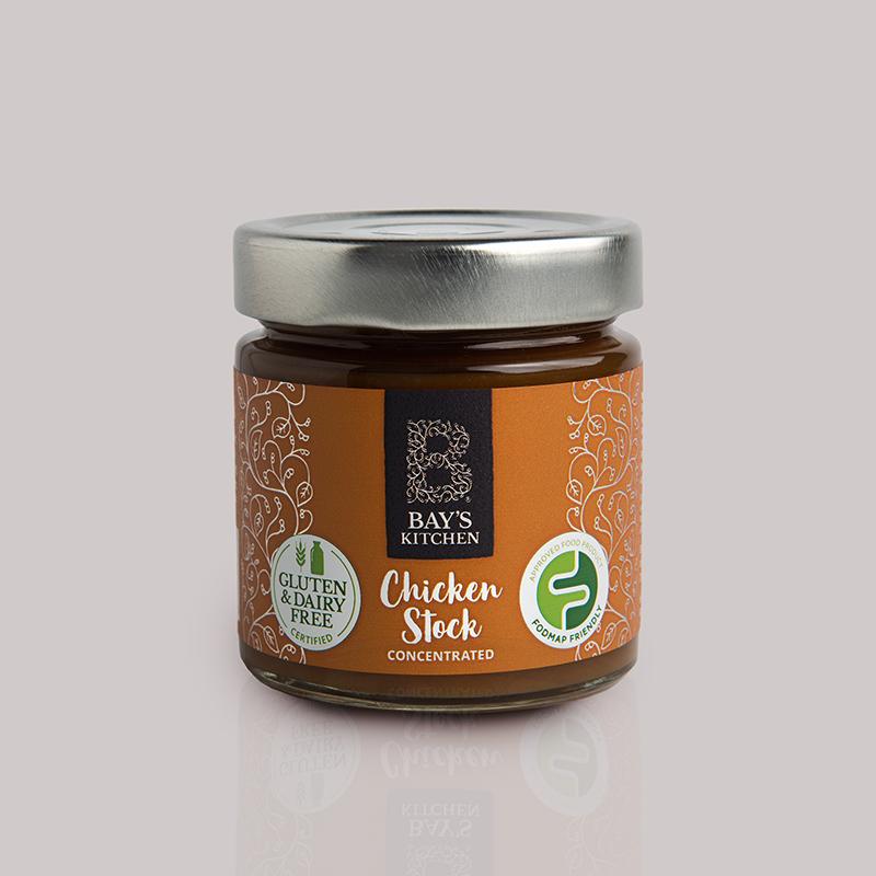 A jar of Bay's Kitchen Chicken stock on a grey background